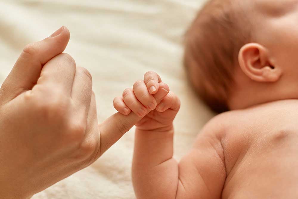 Newborn Holding Hands